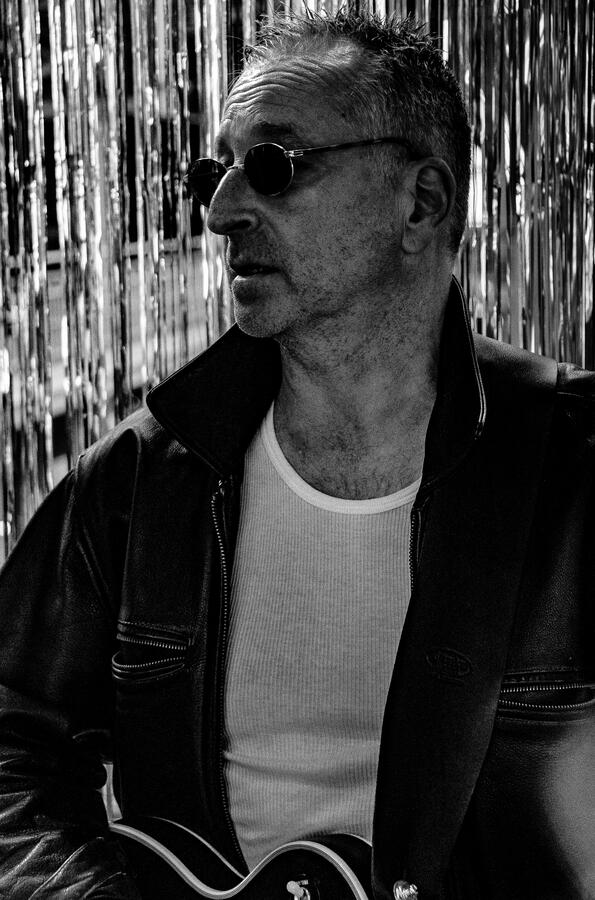 Black-and-white portrait of an independent rock musician with guitar. Black-and-white portrait of an independent rock musician with guitar.